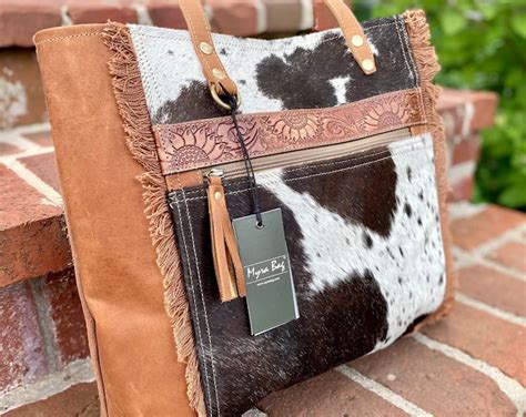 Step up your fashion game with the Myra Cow Print Purse